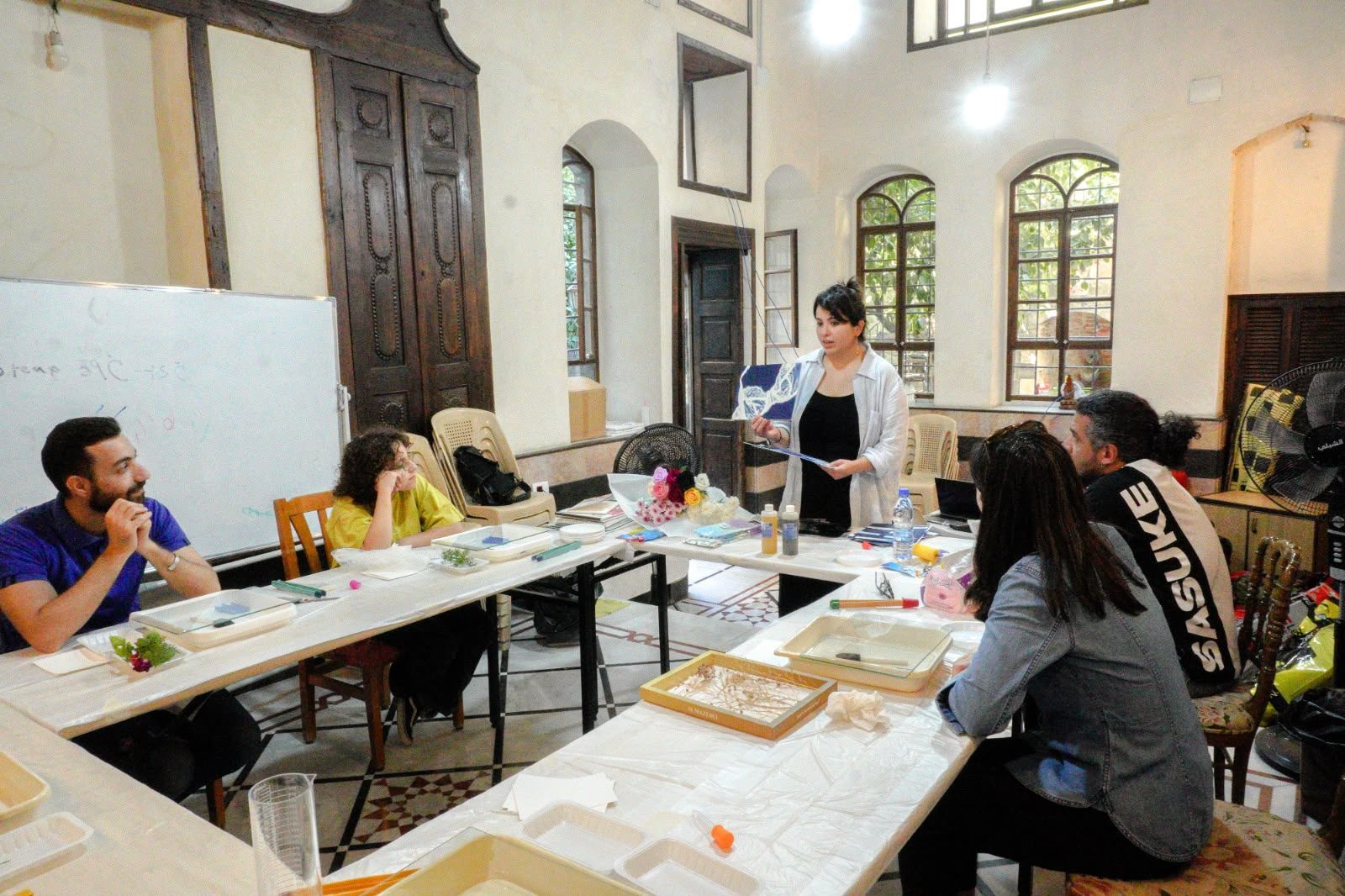 Participant preparing objects for a cyanotype exposure, Damascus, September 2026